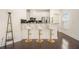 Bright kitchen featuring modern white cabinets, a breakfast bar with seating, and stainless steel appliances at 1884 Plainsboro Dr, Lithonia, GA 30058