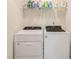 Functional laundry area equipped with a washer and dryer, and ample shelving at 1884 Plainsboro Dr, Lithonia, GA 30058