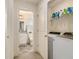 Convenient laundry room with washer, dryer, and storage shelving at 1884 Plainsboro Dr, Lithonia, GA 30058