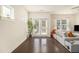 Bright and airy living room featuring hardwood floors, neutral tones, and access to the outdoors at 1884 Plainsboro Dr, Lithonia, GA 30058