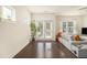 Spacious living room featuring hardwood floors, natural light, and a cozy seating arrangement at 1884 Plainsboro Dr, Lithonia, GA 30058