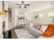 Open-concept living area with fireplace, hardwood floors, and a breakfast bar connecting to the kitchen at 1884 Plainsboro Dr, Lithonia, GA 30058