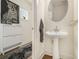 A sleek powder room features a pedestal sink, modern decor, and neutral tones at 1884 Plainsboro Dr, Lithonia, GA 30058