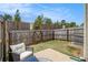 Private fenced backyard featuring a small patio, lawn and gate access at 1884 Plainsboro Drive Dr, Lithonia, GA 30058