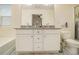 Bathroom featuring a double vanity, granite countertops, soaking tub, and tiled shower with glass door at 1884 Plainsboro Drive Dr, Lithonia, GA 30058