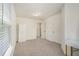Light-filled bedroom with neutral walls, carpet, and access to closets at 1884 Plainsboro Drive Dr, Lithonia, GA 30058