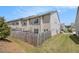 Exterior rear view of home with a fenced yard and well-maintained lawn at 1884 Plainsboro Drive Dr, Lithonia, GA 30058