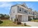 Well-maintained townhome with gray siding, a one-car garage, and a small front yard at 1884 Plainsboro Drive Dr, Lithonia, GA 30058