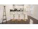 Bright kitchen featuring a breakfast bar with seating, stainless steel appliances, and dark hardwood floors at 1884 Plainsboro Drive Dr, Lithonia, GA 30058