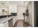 Modern kitchen featuring stainless steel appliances, granite countertops, and dark hardwood floors throughout at 1884 Plainsboro Drive Dr, Lithonia, GA 30058