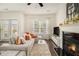 Stylish living room with a fireplace, hardwood floors, and a comfortable gray sectional at 1884 Plainsboro Drive Dr, Lithonia, GA 30058