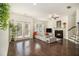 Cozy living room featuring a fireplace, hardwood floors, and a comfortable sectional sofa at 1884 Plainsboro Drive Dr, Lithonia, GA 30058