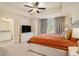 Spacious bedroom featuring a ceiling fan, ensuite bathroom, and large window with decorative curtains at 1884 Plainsboro Drive Dr, Lithonia, GA 30058