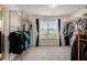 Large walk-in closet with plenty of space for storage and natural light from the window at 1884 Plainsboro Drive Dr, Lithonia, GA 30058