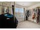 Spacious walk-in closet with metal clothing racks, window and neutral carpet at 1884 Plainsboro Drive Dr, Lithonia, GA 30058