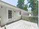 Back deck leading to rear entry door with wooded backdrop and a small window at 301 Jetta Ln, Canton, GA 30115