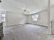Spacious basement with neutral carpet, ceiling fan, and natural light from the windows at 301 Jetta Ln, Canton, GA 30115