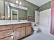 Bathroom featuring a single sink vanity, a tub with shower, and a large mirror above the vanity at 301 Jetta Ln, Canton, GA 30115