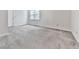 Spacious bedroom with neutral carpet, a window, and a white door at 301 Jetta Ln, Canton, GA 30115