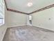 Spacious bedroom with neutral carpet, a window, a white door, and decorative border leading to bath at 301 Jetta Ln, Canton, GA 30115