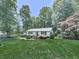 Exterior view of home with green lawn, ornamental trees and black window shutters at 301 Jetta Ln, Canton, GA 30115