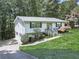 Quaint one-story home with a beautiful yard and driveway leading to a side garage at 301 Jetta Ln, Canton, GA 30115