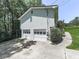 Spacious two-car garage with an access door and driveway situated next to the house at 301 Jetta Ln, Canton, GA 30115