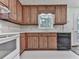 A kitchen featuring wooden cabinets, white countertops, and a window above the sink at 301 Jetta Ln, Canton, GA 30115