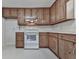 Galley kitchen with white appliances, knotty pine cabinets and ample counter space at 301 Jetta Ln, Canton, GA 30115