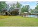 Lush backyard featuring an in-ground pool with a fence, a deck, and a covered patio at 58 First Manassas E Way, Sharpsburg, GA 30277