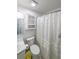 Clean bathroom with a toilet, sink, cabinet, shower and decorative shower curtain at 58 First Manassas E Way, Sharpsburg, GA 30277