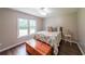 Cozy bedroom features hardwood floors, window and trunk at 58 First Manassas E Way, Sharpsburg, GA 30277