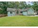 Charming home features a well-manicured lawn and appealing stone accents at 58 First Manassas E Way, Sharpsburg, GA 30277