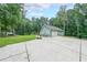 Long driveway leading to a large two car garage with basketball hoop at 58 First Manassas E Way, Sharpsburg, GA 30277