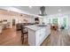Open-concept kitchen with granite island seamlessly connecting to the living area and dining nook at 58 First Manassas E Way, Sharpsburg, GA 30277