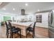 Beautiful kitchen features a center island, stainless appliances and white cabinetry at 58 First Manassas E Way, Sharpsburg, GA 30277