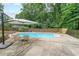 Enjoy the pool with an umbrella and chairs at 58 First Manassas E Way, Sharpsburg, GA 30277