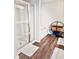 Modern bathroom featuring a glass-enclosed shower, soaking tub, and stylish shelving for storage and decor at 6128 Lanier Harbor Lndg, Buford, GA 30518