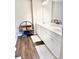Bright bathroom with a double vanity, sleek fixtures, modern shelving unit, and a minimalist design at 6128 Lanier Harbor Lndg, Buford, GA 30518