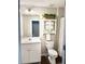 Well-lit bathroom with a white vanity, decorative cabinet, and a clean, modern toilet and shower at 6128 Lanier Harbor Lndg, Buford, GA 30518
