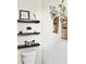 Stylish bathroom with floating shelves, greenery, and a modern toilet at 6128 Lanier Harbor Lndg, Buford, GA 30518