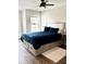 Comfortable bedroom featuring a cozy bed with built-in storage and a modern accent rug on hardwood floors at 6128 Lanier Harbor Lndg, Buford, GA 30518