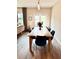 Bright dining room with wooden table, six navy chairs and natural light from back patio at 6128 Lanier Harbor Lndg, Buford, GA 30518