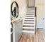 Inviting entryway with hardwood floors, a stylish console table, and stairs leading to the upper level at 6128 Lanier Harbor Lndg, Buford, GA 30518