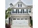 Charming two-story home featuring a gray brick facade, white siding, and a spacious two-car garage at 6128 Lanier Harbor Lndg, Buford, GA 30518