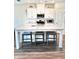 Bright kitchen with granite countertops, white cabinets, stainless appliances, and an island with stools at 6128 Lanier Harbor Lndg, Buford, GA 30518
