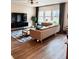 Cozy living room featuring hardwood floors, a large sofa, and a modern entertainment center at 6128 Lanier Harbor Lndg, Buford, GA 30518