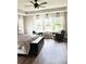 Bright main bedroom with a ceiling fan, large windows with sheer curtains, and cozy seating area at 6128 Lanier Harbor Lndg, Buford, GA 30518