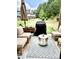 Inviting outdoor patio with comfortable seating, a grill, and a view of the green backyard at 6128 Lanier Harbor Lndg, Buford, GA 30518