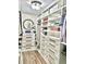 Custom walk-in closet featuring built-in shelving and drawers for organized storage at 6128 Lanier Harbor Lndg, Buford, GA 30518